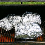 Brisket pieces returned to the smoker, wrapped in foil