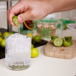 Squeezing limes into the drink Squeezing limes into the drink